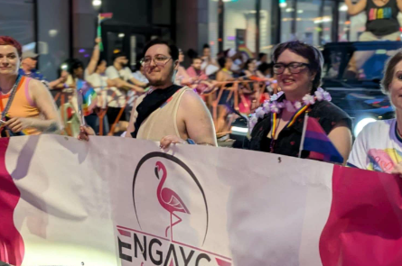 Engayge members carrying the organization banner in a Pride parade